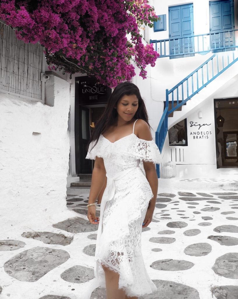 Bonnie Rakhit in Mykonos wearing very.co.uk white lace dress with bougonvillea flowers