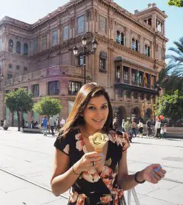 Bonnie Rakhit travel blogger in seville with floral icecream