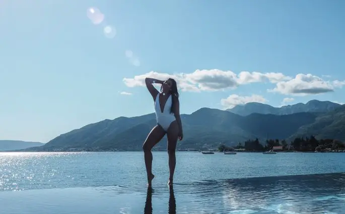 Bonnie Rakhit Style Traveller at Regent porto Montenegro luxury hotel beautiful infinity pool white asos swimsuit