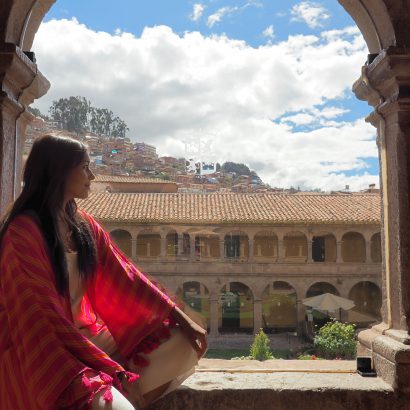 Belmond Monasterio best luxury hotels girl sat in archway with monastery view Bonnie Rakhit