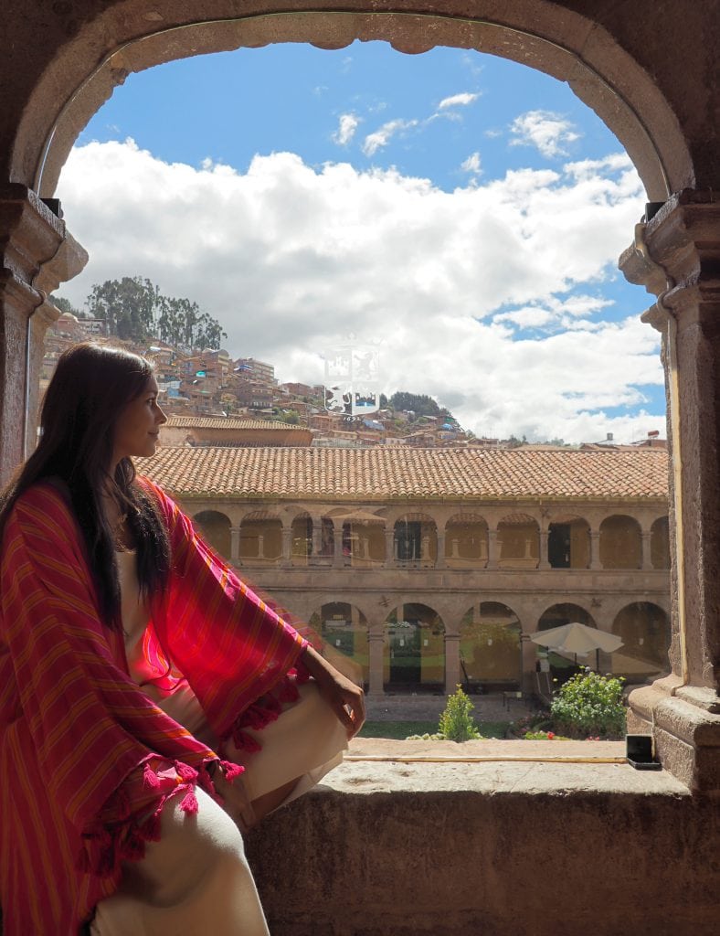 Belmond Monasterio best luxury hotels girl sat in archway with monastery view Bonnie Rakhit