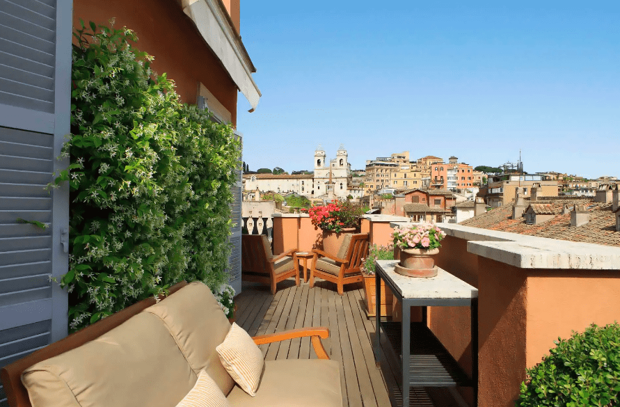 Living La Dolce Vita in Rome - Portrait Roma suite terrace by day with stunning views of Rome